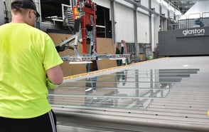 An employee stands in front of the new Glaston FC furnace clamping glasses.